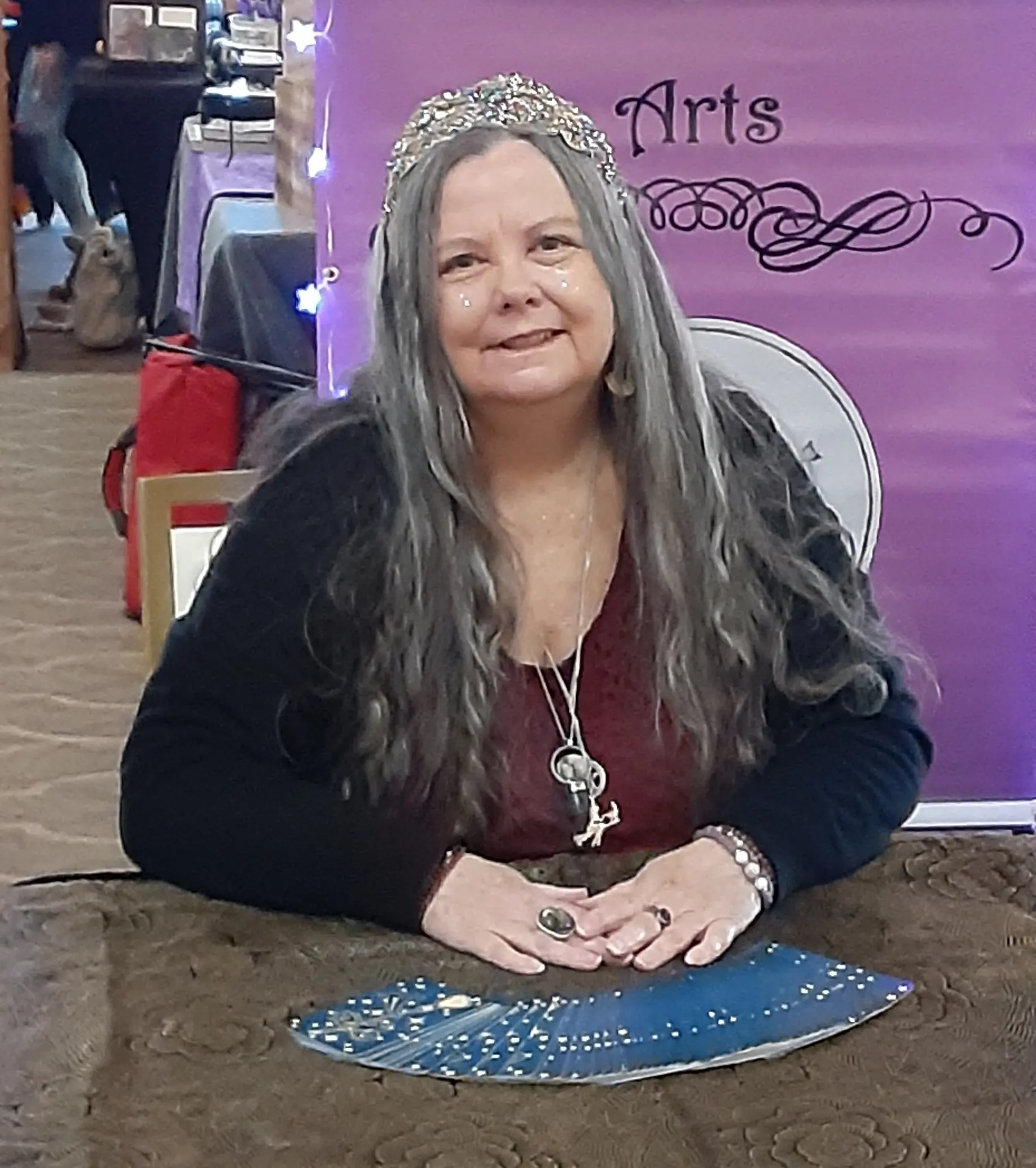 A woman sitting at a table with a blue plate.