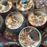 A group of candles with different types of rocks inside them.
