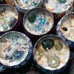 A group of candles with various decorations in them.