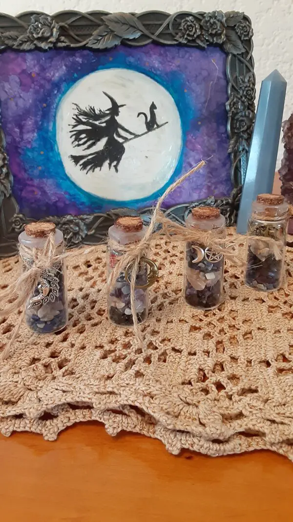 A table with four jars of dried fruit.